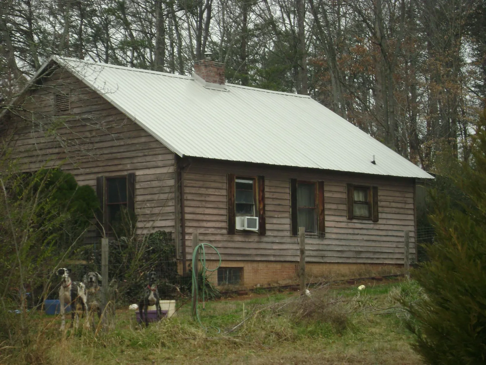 White metal roof on an old wood sided farmhouse, from a Metal Roof Installation job in West Boylston